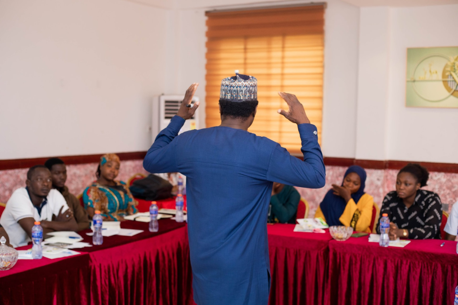 Facilitator leading a training session with seated participants